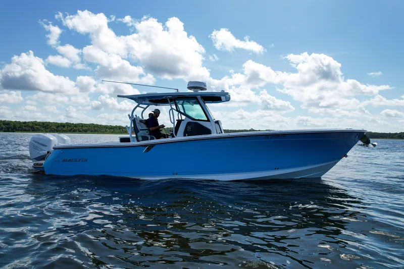 Slide: The Image of 2023 Blackfin 332 CC boat cruising on a sunny day with clear skies. - 10