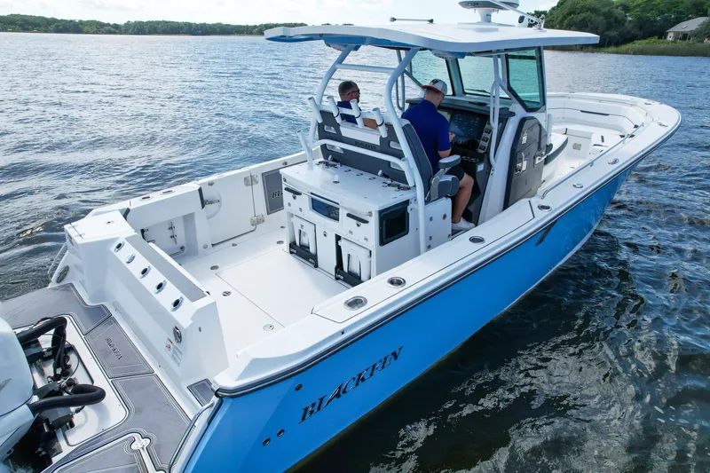 Slide: The Image of 2023 Blackfin 332 CC boat on water, featuring spacious deck and modern design. - 6