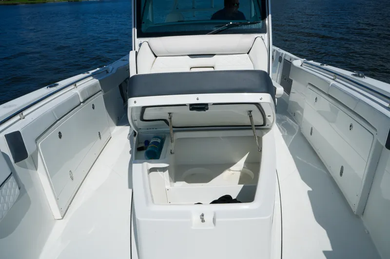 Slide: The Image of 2023 Blackfin 332 CC boat interior with open storage compartment on deck. - 38