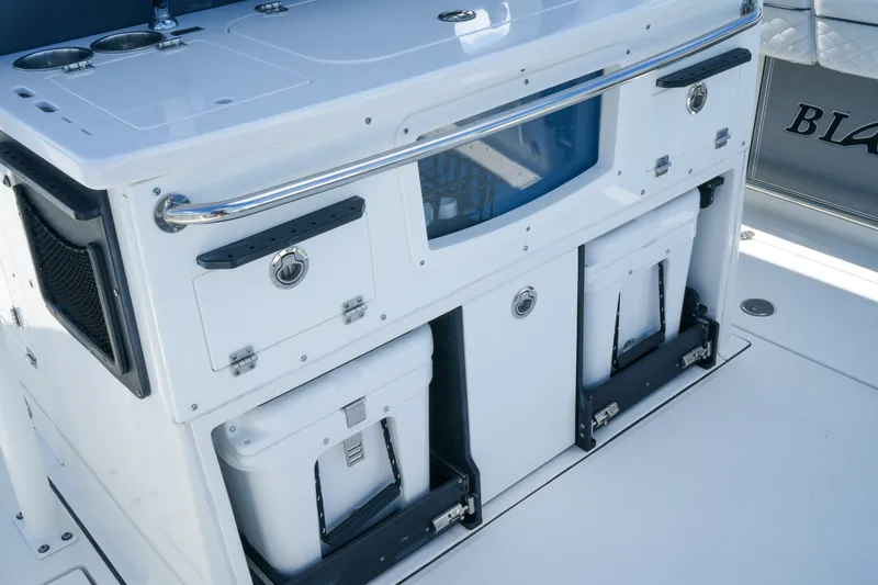 Slide: The Image of 2023 Blackfin 332 CC boat interior with storage compartments and coolers. - 29