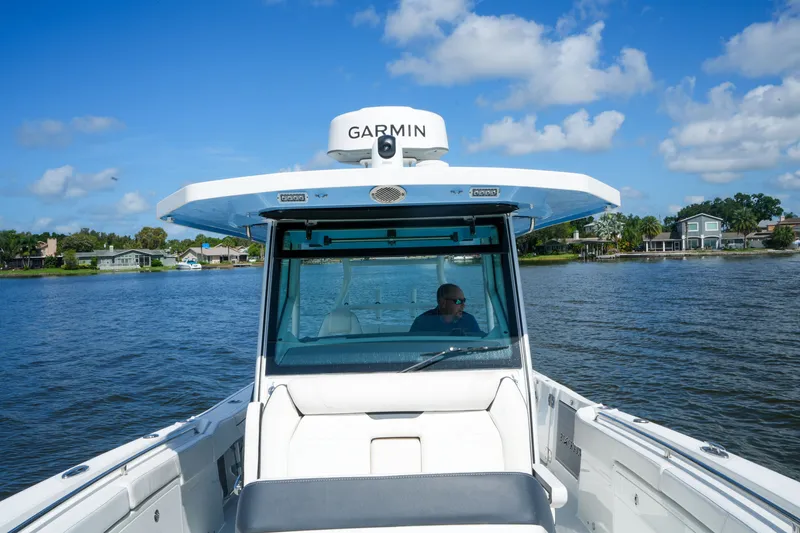 Slide: The Image of 2023 Blackfin 332 CC boat cruising on a sunny day with Garmin equipment. - 15