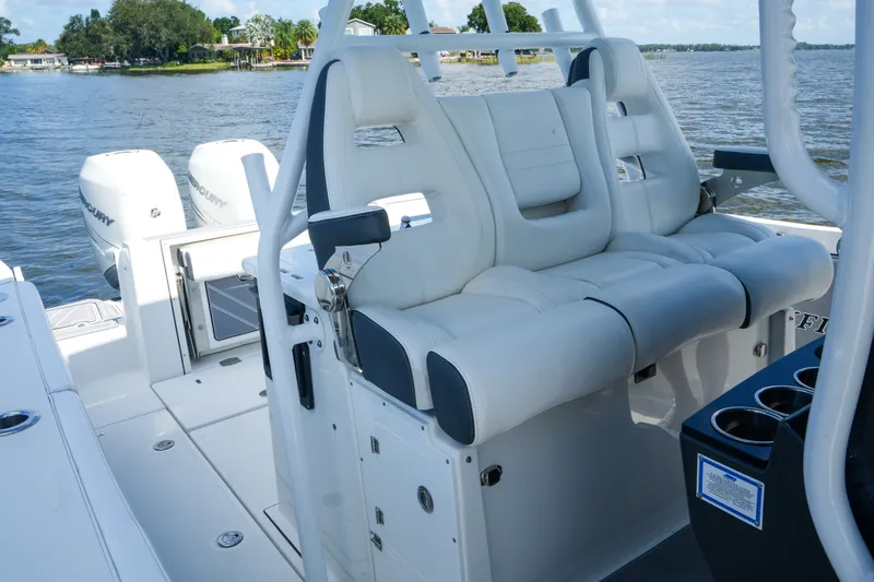 Slide: The Image of 2023 Blackfin 332 CC boat interior with white seating and dual Mercury engines. - 40
