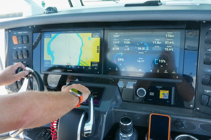 Slide: The Image of Dashboard of a 2023 Blackfin 332 CC boat with navigation and control screens. - 46