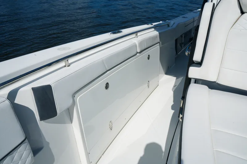 Slide: The Image of 2023 Blackfin 332 CC boat interior with white seating and storage compartment. - 37