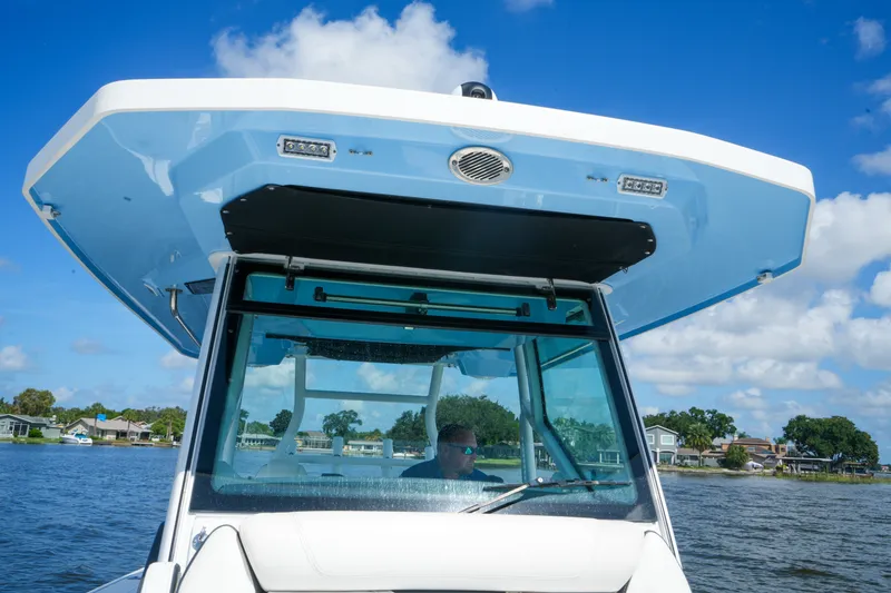 Slide: The Image of 2023 Blackfin 332 CC boat cruising on a sunny day with blue skies. - 39