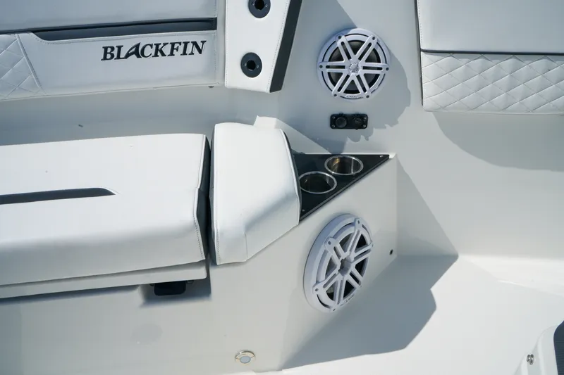 Slide: The Image of 2023 Blackfin 332 CC boat interior with speakers and cup holders. - 36