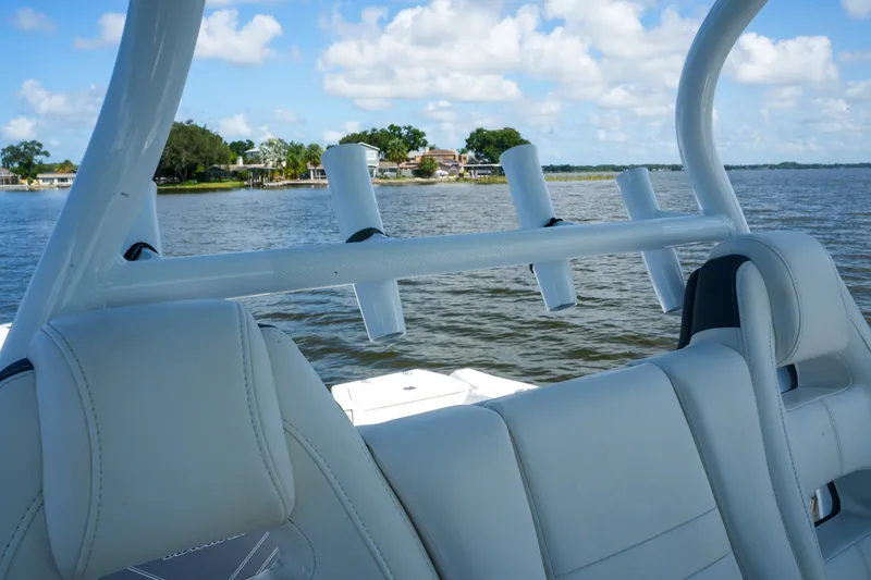 Slide: The Image of 2023 Blackfin 332 CC boat interior with rod holders on a sunny day. - 43