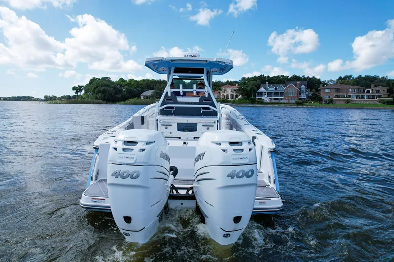 Slide: The Image of 2023 Blackfin 332 CC boat with twin Mercury 400 engines on a scenic lake. - 4
