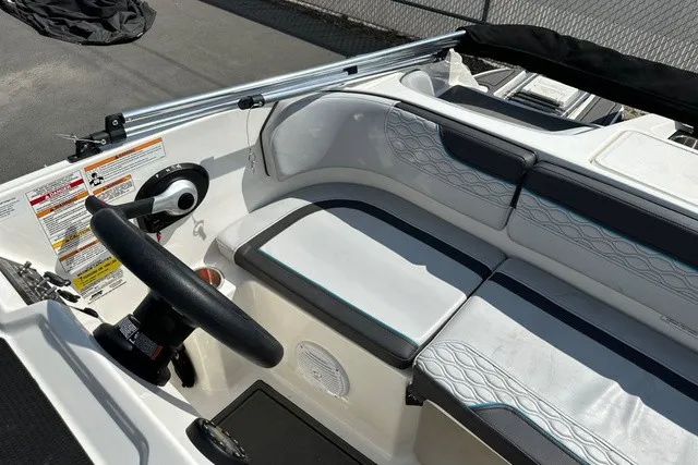 Slide: The Image of The image shows the cockpit of a 2024 Bayliner M17 with white and gray seating. - 17