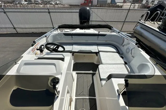 Slide: The Image of The image shows the cockpit of a 2024 Bayliner M17 with white seating and a black steering wheel. - 9