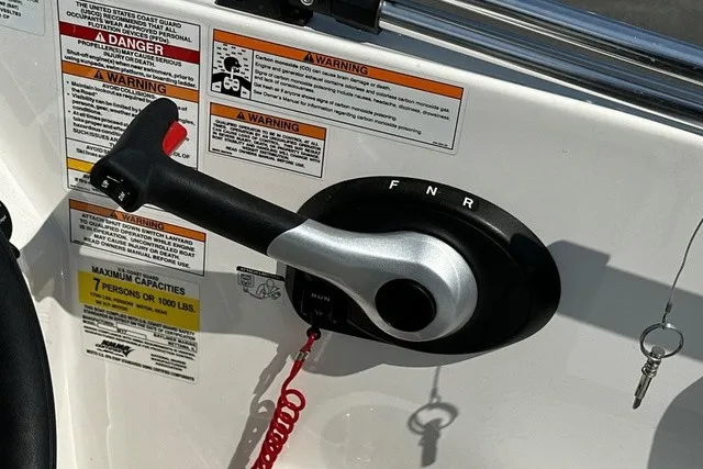 Slide: The Image of Close-up of a throttle lever with warning labels and an ignition key on the panel. - 8