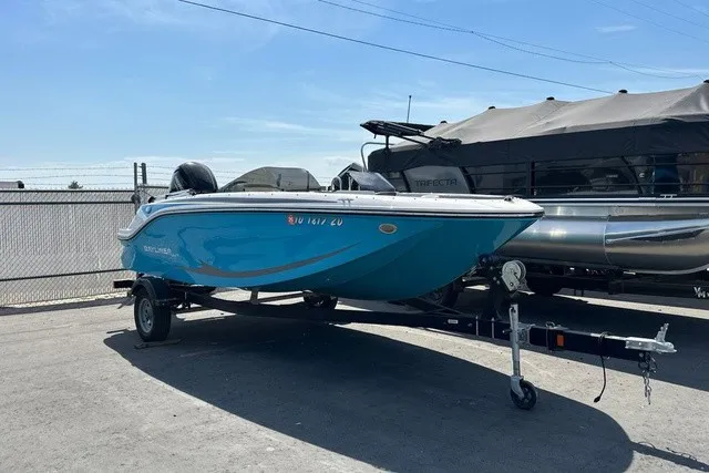 Slide: The Image of A blue 2024 Bayliner M17 is on a trailer in an outdoor setting. - 2