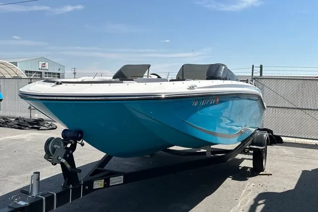 Slide: The Image of A blue and white 2024 Bayliner M17 sits on a trailer in a fenced area. - 6