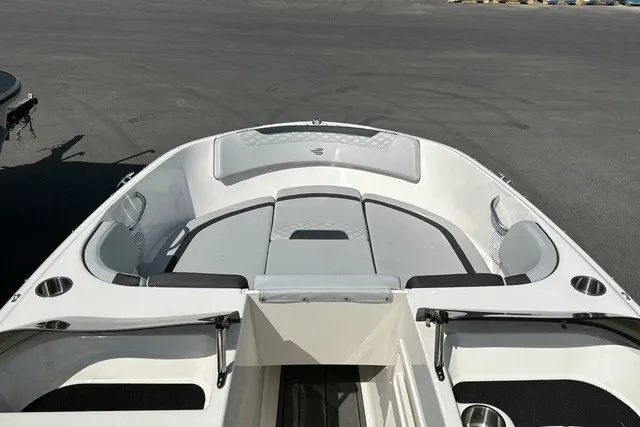 Slide: The Image of The image shows the bow of a 2024 Bayliner M17 boat with gray upholstery. - 13