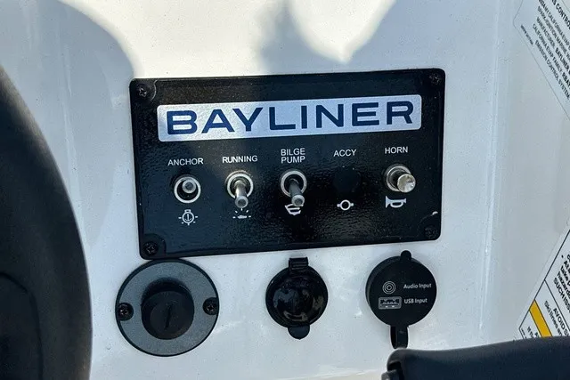 Slide: The Image of Close-up of a control panel with toggle switches and ports on a Bayliner boat. - 21