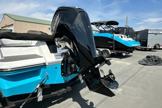 Slide: The Image of A 2024 Bayliner M17 with a Mercury outboard motor. It is parked alongside other boats. - 4