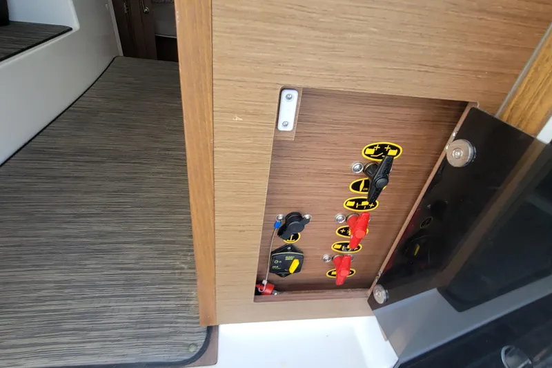 Slide: The Image of Electrical panel on 2023 Jeanneau NC 895 boat, featuring switches and controls. - 19