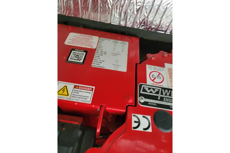 Slide: The Image of Engine compartment of 2023 Jeanneau NC 895 with warning labels and QR code. - 28