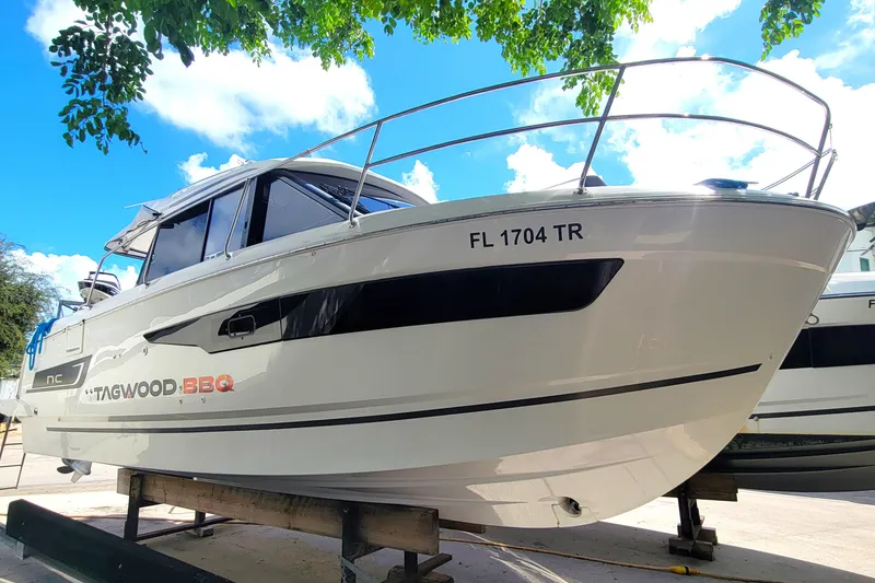 Slide: The Image of 2023 Jeanneau NC 895 boat on display under a clear blue sky. - 2