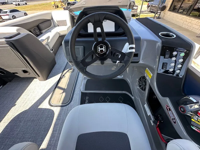 Slide: The Image of The image shows the cockpit of a 2027 Harris Sunliner 230 with a modern steering wheel and controls. - 22