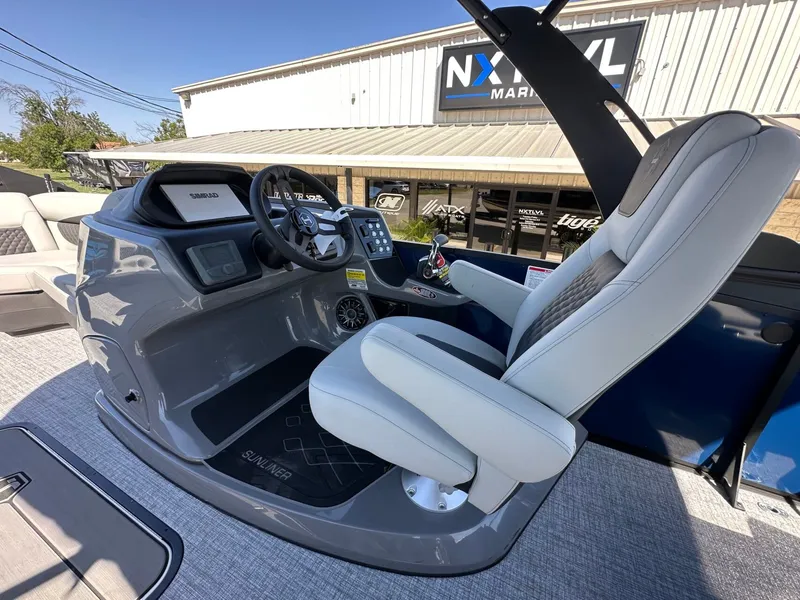 Slide: The Image of The image shows the cockpit of a 2027 Harris Sunliner 230 with a modern helm station. - 21