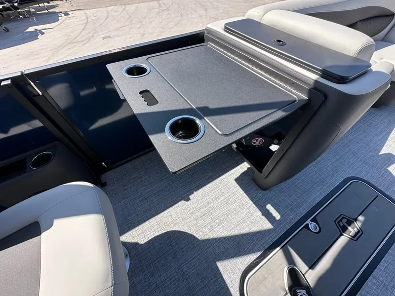 Slide: The Image of A table with cup holders on a 2027 Harris Sunliner 230 pontoon boat. - 38