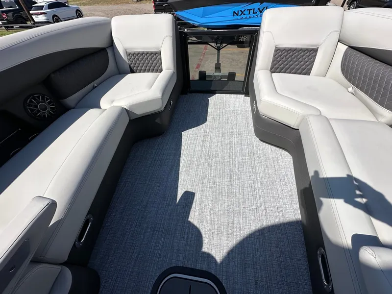 Slide: The Image of Interior of a 2027 Harris Sunliner 230 with gray upholstered seating and carpeted flooring. - 25