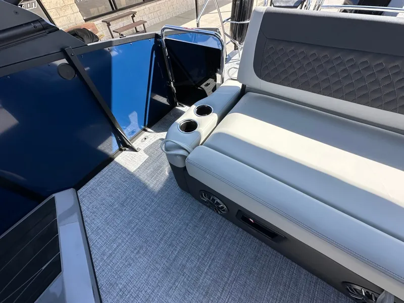 Slide: The Image of The image shows the interior of a 2027 Harris Sunliner 230 with cushioned seating and cup holders. - 16