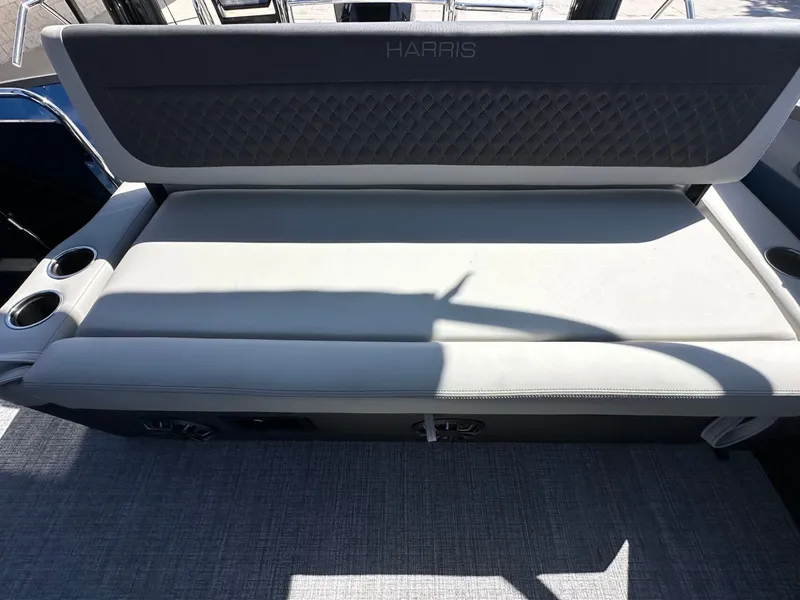 Slide: The Image of The 2027 Harris Sunliner 230 features a cushioned bench seat with cup holders. - 17