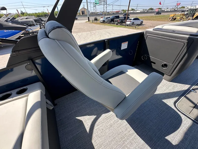 Slide: The Image of A modern seat on a Harris Sunliner 230 pontoon boat, surrounded by gray carpeting. - 19
