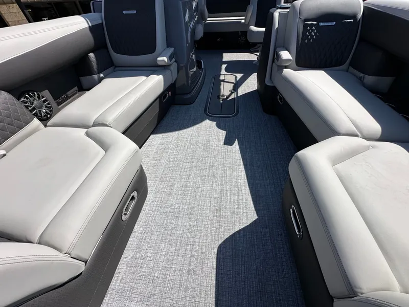 Slide: The Image of Interior of a 2027 Harris Sunliner 230 with gray upholstery and carpeted flooring. - 28