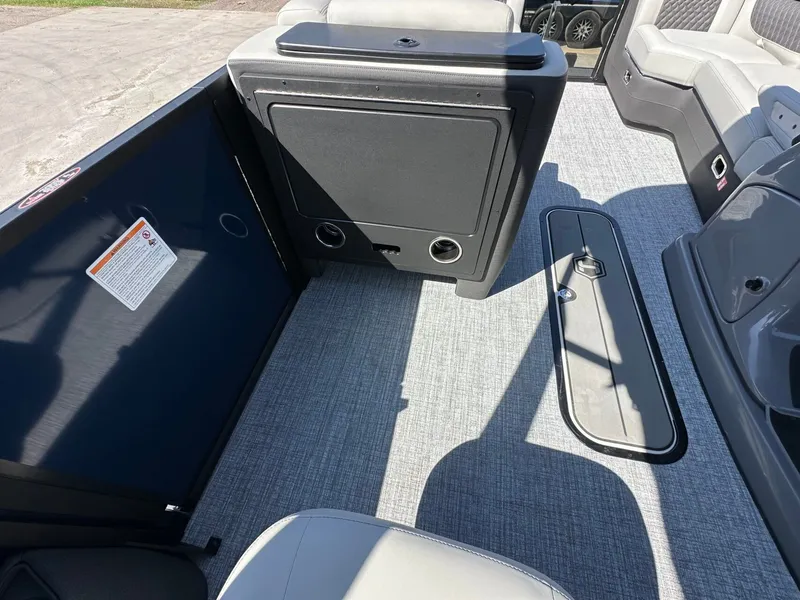 Slide: The Image of The image shows the interior of a 2027 Harris Sunliner 230 with gray carpeting. - 23