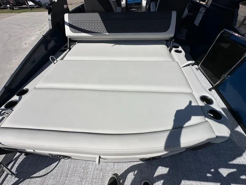 Slide: The Image of The image shows a lounging area on a 2027 Harris Sunliner 230 boat. - 14