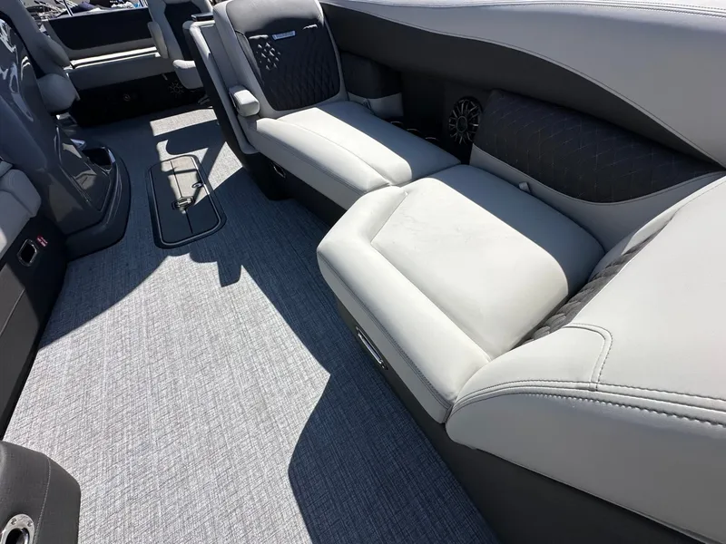 Slide: The Image of The image shows the interior of a 2027 Harris Sunliner 230 with gray upholstered seating. - 29
