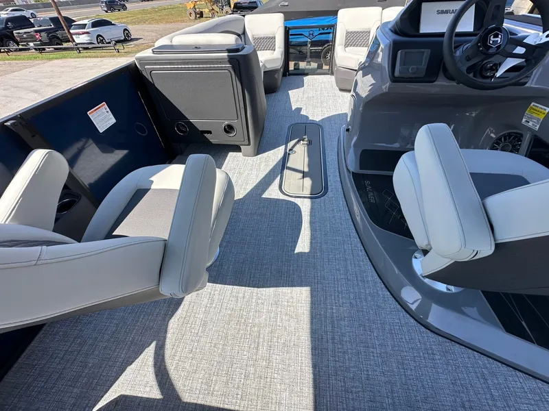 Slide: The Image of Interior of a Harris Sunliner 230 pontoon boat with gray seating and a modern helm. - 20