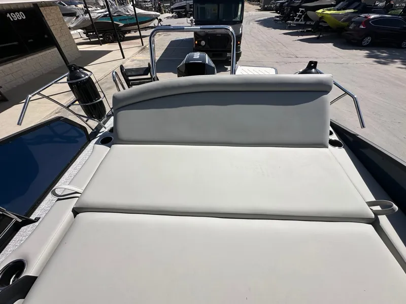 Slide: The Image of The image shows the sun deck of a 2027 Harris Sunliner 230, situated in a showroom. - 36