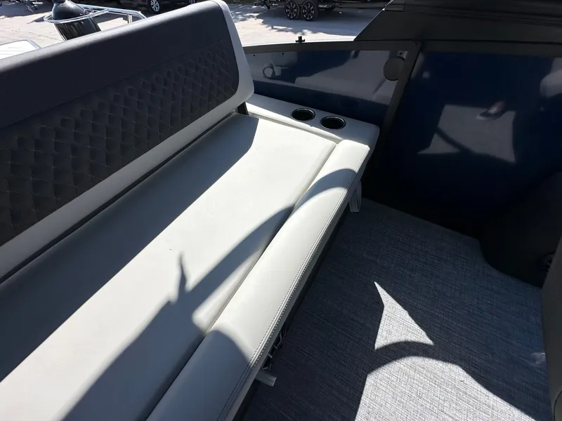 Slide: The Image of The 2027 Harris Sunliner 230 features a cushioned bench seat with cup holders. - 18