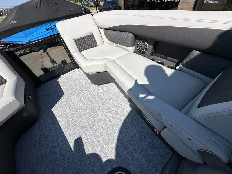 Slide: The Image of The image shows the interior of a 2027 Harris Sunliner 230 with sleek, upholstered seating. - 26