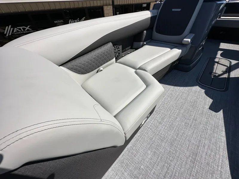 Slide: The Image of The image shows the luxurious seating of a 2027 Harris Sunliner 230 with gray upholstery. - 27