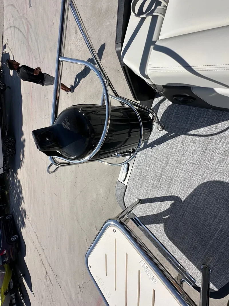 Slide: The Image of A sleek pontoon boat with polished metal railings and comfortable white seating. - 39