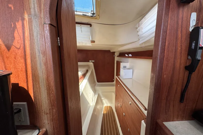 Slide: The Image of Interior of 2007 Gemini 105 MC sailboat with wooden cabinetry and natural light. - 18