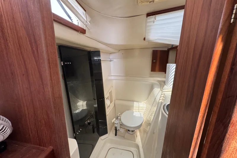 Slide: The Image of Compact bathroom interior of 2007 Gemini 105 MC catamaran with wooden accents. - 24