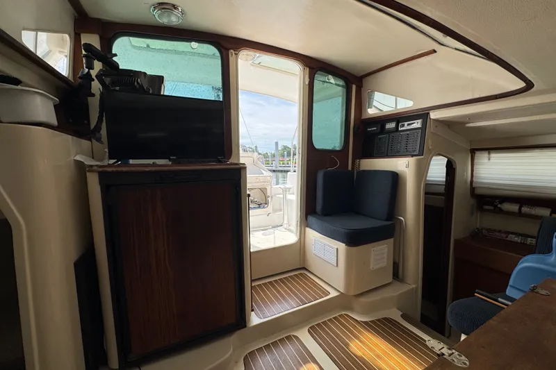 Slide: The Image of Interior of a 2007 Gemini 105 MC catamaran with seating and navigation equipment. - 14