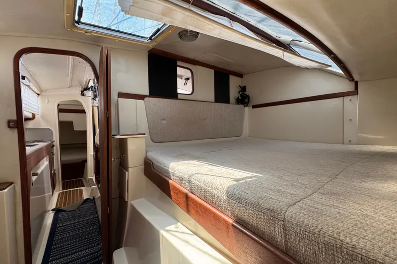 Slide: The Image of Interior of a 2007 Gemini 105 MC catamaran, featuring a cozy cabin and skylight. - 20