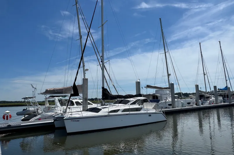 Slide: The Image of 2007 Gemini 105 MC catamaran docked at marina under clear blue sky. - 2