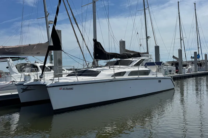The Image of 2007 Gemini 105 MC catamaran docked at marina, surrounded by other sailboats. - 1