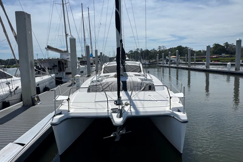 Slide: The Image of 2007 Gemini 105 MC catamaran docked at a marina under a clear sky. - 3