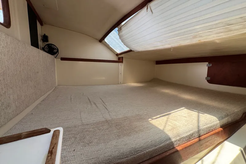 Slide: The Image of Interior cabin of a 2007 Gemini 105 MC sailboat, featuring a cozy sleeping area. - 19