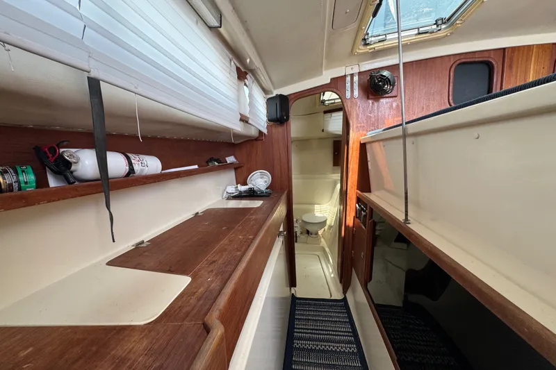 Slide: The Image of 2007 Gemini 105 MC yacht interior with wooden cabinetry and compact bathroom. - 23