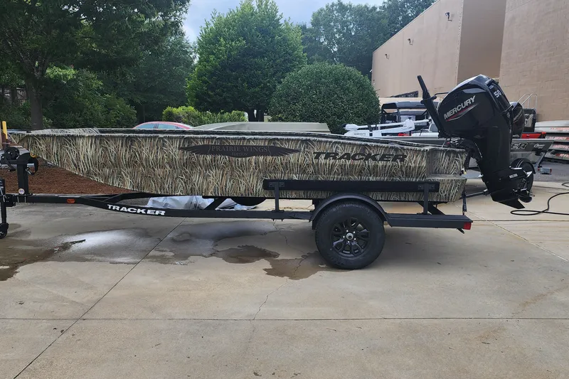 The Image of 2027 Tracker Grizzly 1650 T Prairie Wings Edition boat on trailer, camo design. - 1